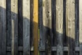 Old wooden fence in sunlight and shadow