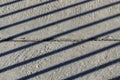 Diagonal shadow lines on concrete surface. Horizontal line of separation of concrete slabs in the center.