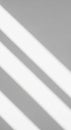 Diagonal shadows cast by parallel lines cross a plain surface. The alternating pattern o Royalty Free Stock Photo