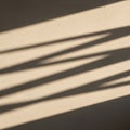 Diagonal shadows cast on a textured beige wall create a pattern of parallel lines. The shadows Royalty Free Stock Photo