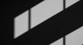 Diagonal shadows and light patterns form rectangular shapes on a dark surface, Royalty Free Stock Photo
