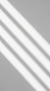 Diagonal shadows of parallel lines cast on a smooth gray surface. The lines are evenly Royalty Free Stock Photo