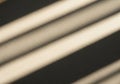 Diagonal shadows from window blinds cast Royalty Free Stock Photo