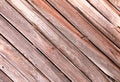 Diagonal slanted barn wall siding boards weathered faded and worn as an interior or exterior design architectural scene