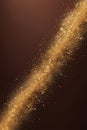 Diagonal stream of glowing gold particles on dark brown background. Abstract festive texture with motion effect Royalty Free Stock Photo