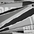 Diagonal strips of torn paper reveal layers beneath, showcasing black and white abst Royalty Free Stock Photo
