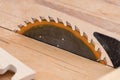 Diagonal view of circular saw near the saw blade part of the wood workpiece Royalty Free Stock Photo