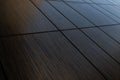 Diagonal view of dark brown venge tile wall surface, wood imitation texture