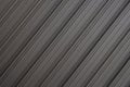 Diagonal view of gray striped ribbed surface, background pattern, building themes.