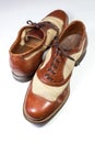 Diagonal view of a pair of men`s vintage leather wing tip shoes,