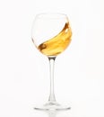 Diagonal wave of white wine, champagne is in glass.