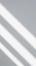 Diagonal white light beams on a gray surface create a minimalist, abstract pattern. The Royalty Free Stock Photo