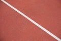 Diagonal white line marking red stadium with soft coverings for sports Royalty Free Stock Photo