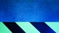 Diagonal yellow and black stripes on a blue problem wall. Abstract colorful minimalist pattern. Warning warning sticky tape on