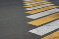 Diagonal yellow and white pedestrian crosswalk across the road