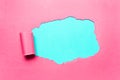 Diagonally torn pink paper with empty space for text of cyan background. Royalty Free Stock Photo
