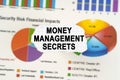 On diagrams and graphs lies torn paper with the inscription - Money Management Secrets