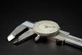 A dial caliper lying on a black background Royalty Free Stock Photo