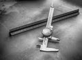 Dial caliper and ruler on a machine shop steel bench Royalty Free Stock Photo