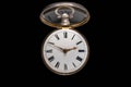 Dial of silver antique pocket watch with an open glass lid on isolated black background. Old mechanical clock. Round Royalty Free Stock Photo