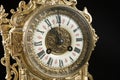 Dial of vintage bronze clock, antique clock photo close up, old bronze clock in gilding, eleven o`clock on the dial, 11 am on the Royalty Free Stock Photo