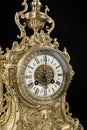 dial of vintage bronze clock on black background, antique clock photo close up, old bronze clock in gilding, six o`clock on the d Royalty Free Stock Photo
