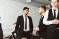 Dialogue of two men at work, young businessmen in suits working and communicating together in an office. Corporate Royalty Free Stock Photo