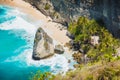 Diamond beach with ocean, coconut palms and rock in Nusa Penida