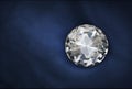 Diamond on blue fabric background Royalty Free Stock Photo