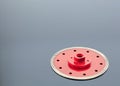 Diamond cutting wheel is red with a threaded nut on the mirror surface of a gray background with a slight gradient Royalty Free Stock Photo