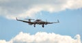 Twin engine piston aircraft during approach for landing on cloudy, sunny sky. Royalty Free Stock Photo