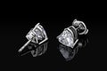 Diamond earrings. Luxury earrings gemstone diamond heart shape cut isolated on black background Royalty Free Stock Photo