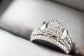 A diamond engagement ring .in a box with glint/reflection. Shimmering princess-cut diamonds. Royalty Free Stock Photo