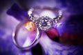 Diamond engagement ring on purple background. Royalty Free Stock Photo