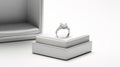 A diamond engagement ring in a white jewelry box on a gray background. This image portrays a romantic and elegant