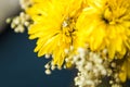 A diamond engagement ring in a yellow boquet of flowers - close up