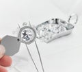 Diamond Grading Under Magnifying Glass with Scoop of Diamonds