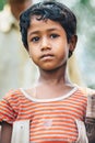 DIAMOND HARBOR, INDIA - MARCH 30, 2013: Poor rural indian boy with a sad eyes close-up portrait