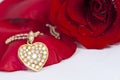 Diamond heart shape pendant and red rose Royalty Free Stock Photo