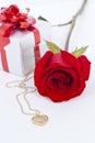 Diamond heart shape pendant and red rose Royalty Free Stock Photo