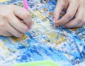 Diamond mosaic painting, fragment of painting close-up, handmade hobby