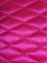 Diamond pattern stitched in pink fabric