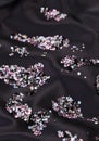 Diamond (purple jewel) stones over black silk Royalty Free Stock Photo