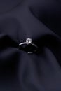 Diamond ring on black silk background with copy space Royalty Free Stock Photo
