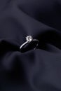 Diamond ring on black silk background with copy space Royalty Free Stock Photo