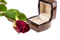 Diamond ring in box with red rose on white background Royalty Free Stock Photo