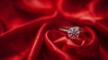 A diamond ring in focus on a red silk or fabric background. Valentines day Royalty Free Stock Photo