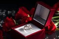 Diamond ring in its box, surrounded by red roses Royalty Free Stock Photo