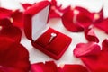 Diamond ring in red velvet gift box on bed sheet Royalty Free Stock Photo