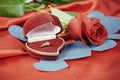 diamond ring and rose on bright red background Royalty Free Stock Photo